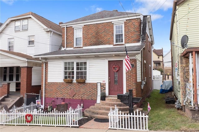 view of front of property with entry steps, fence, and brick siding