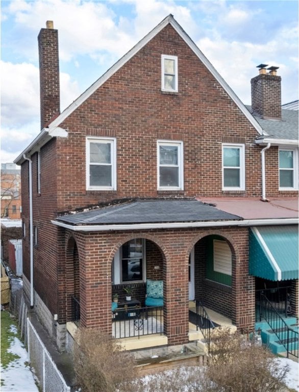 rear view of house with covered porch