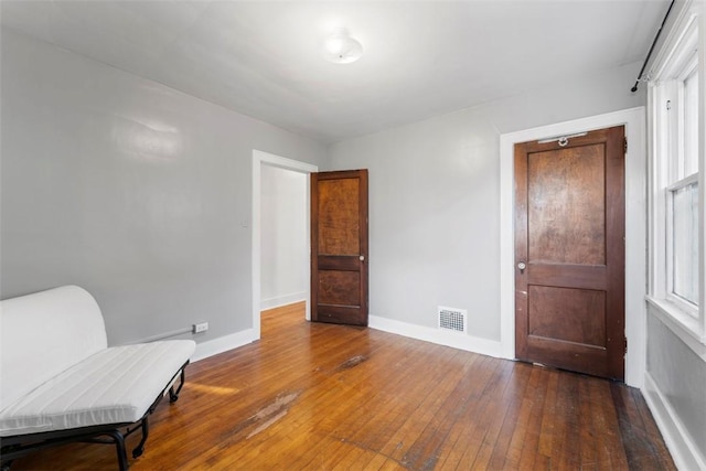 sitting room with wood-type flooring