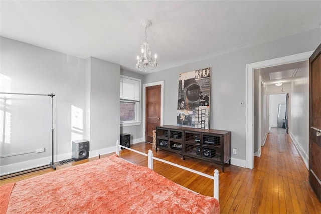 interior space with a chandelier and hardwood / wood-style floors