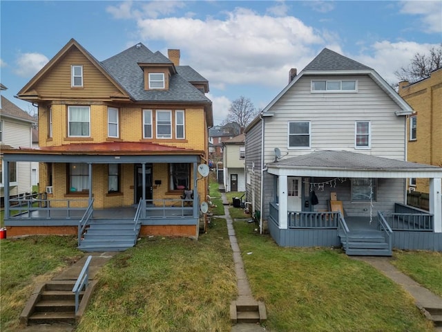 view of front facade with a front yard and covered porch