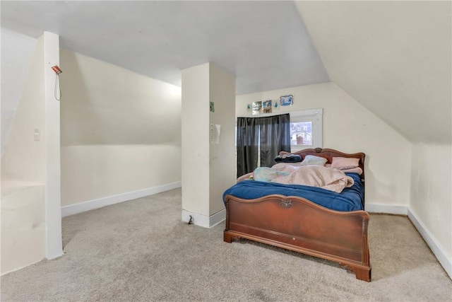 bedroom featuring lofted ceiling and light colored carpet