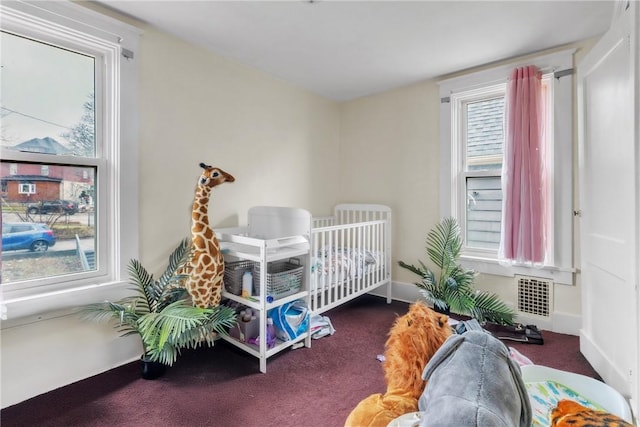 carpeted bedroom featuring multiple windows