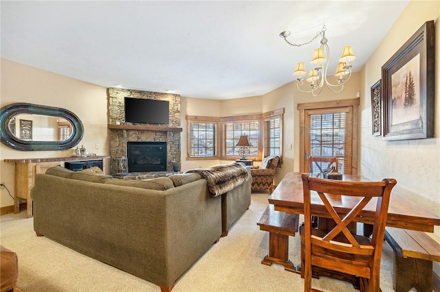 living room featuring an inviting chandelier, a stone fireplace, and light colored carpet