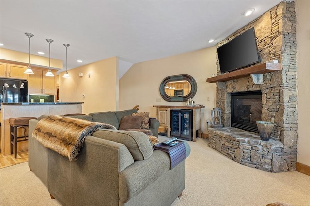 living room with light colored carpet and a fireplace