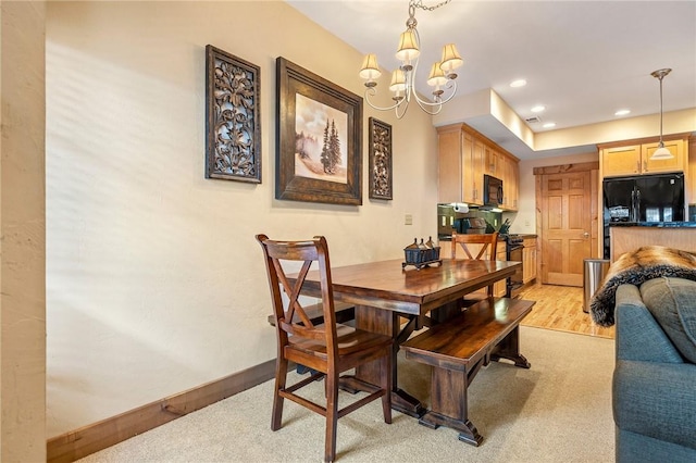 dining area with a chandelier and light wood-type flooring