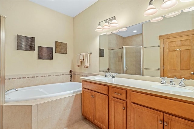 bathroom with tile patterned flooring, shower with separate bathtub, and vanity