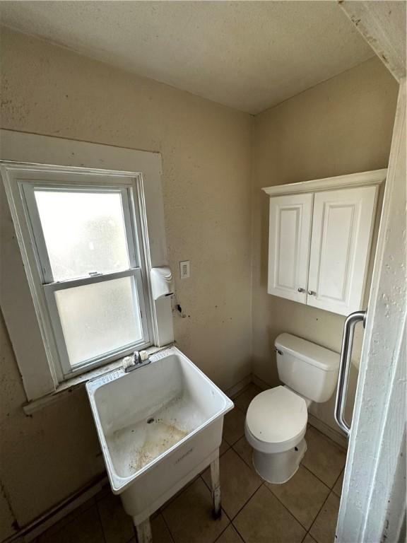 bathroom with tile patterned flooring, sink, and toilet