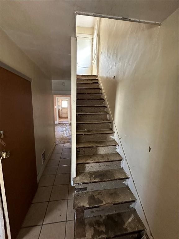 stairway featuring tile patterned floors