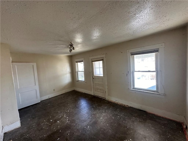 entrance foyer featuring plenty of natural light and a textured ceiling