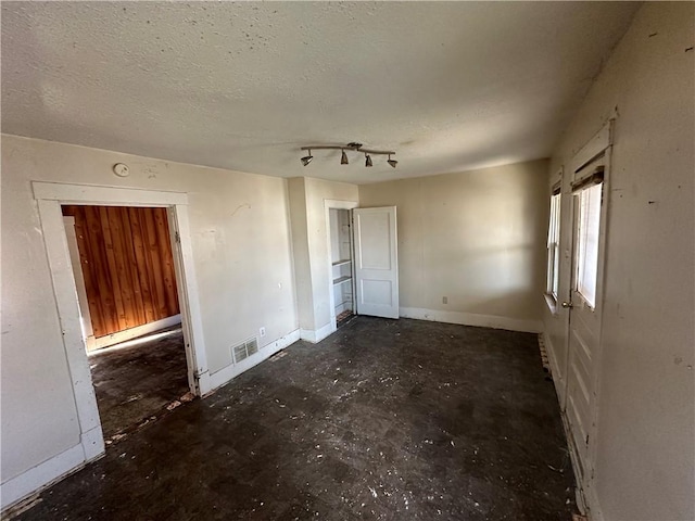 unfurnished bedroom featuring a textured ceiling