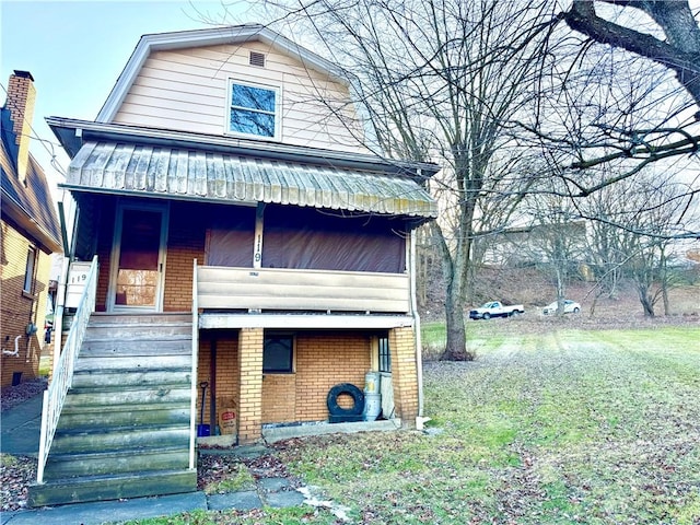 view of front of house featuring a porch, brick siding, a gambrel roof, and stairs