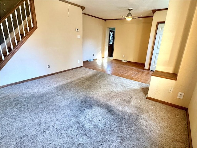 unfurnished room with crown molding, ceiling fan, and carpet flooring