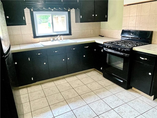 119 Whitestown Rd, Twp Of But Se, PA 16045 - kitchen with black appliances, backsplash, a sink, light countertops, and dark cabinets