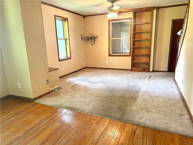 119 Whitestown Rd, Twp Of But Se, PA 16045 - empty room featuring crown molding, ceiling fan, baseboards, wood-type flooring, and carpet flooring