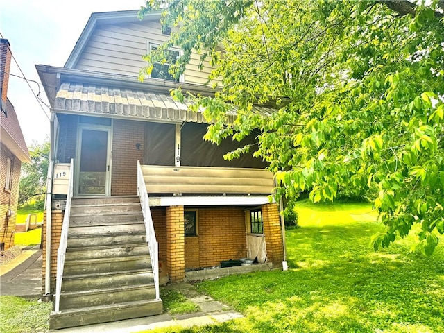 119 Whitestown Rd, Twp Of But Se, PA 16045 - rear view of house with brick siding, a lawn, and stairway