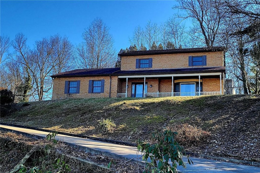 view of property featuring covered porch