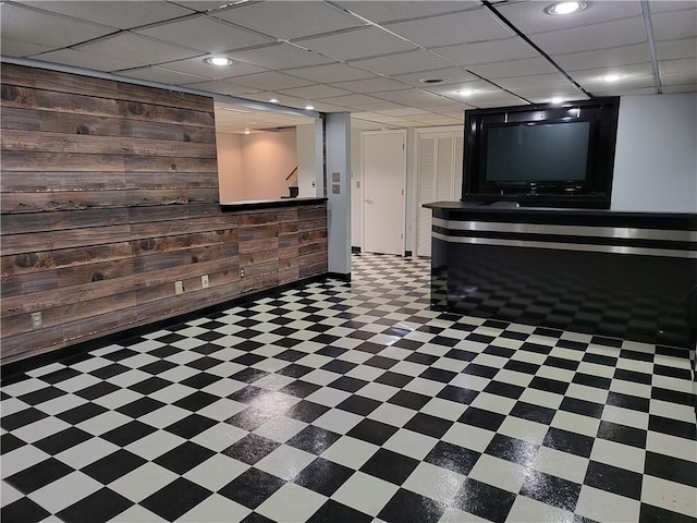 basement featuring wooden walls