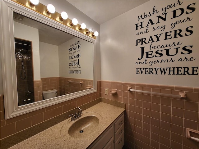 bathroom featuring vanity, tile walls, walk in shower, and toilet