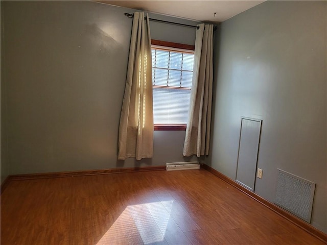 empty room with hardwood / wood-style floors