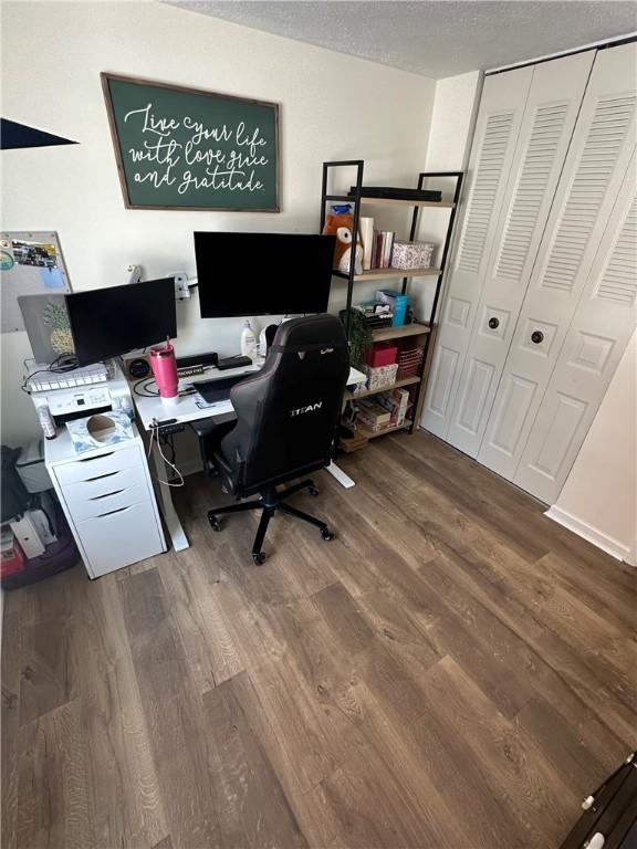 office area featuring wood-type flooring and a textured ceiling