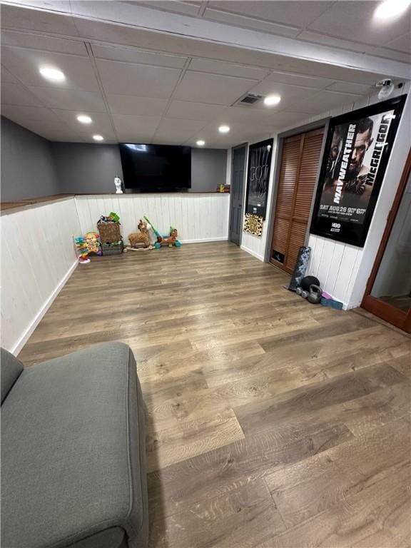 interior space featuring hardwood / wood-style flooring and a paneled ceiling