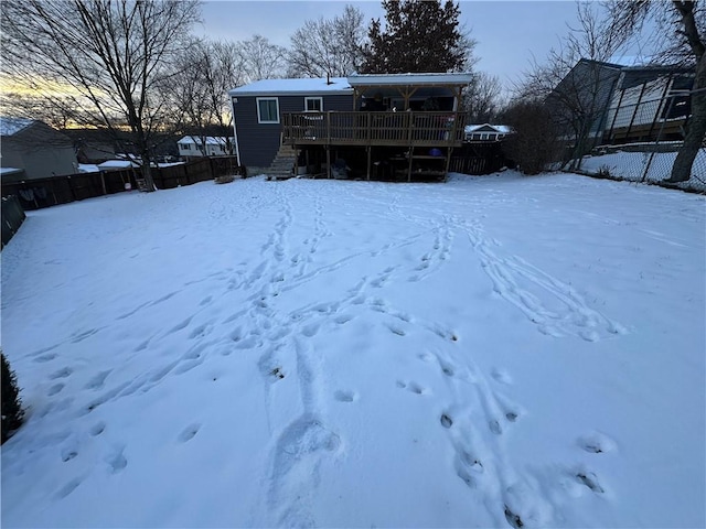 snowy yard featuring a deck