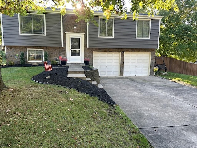 split foyer home with a garage and a front lawn