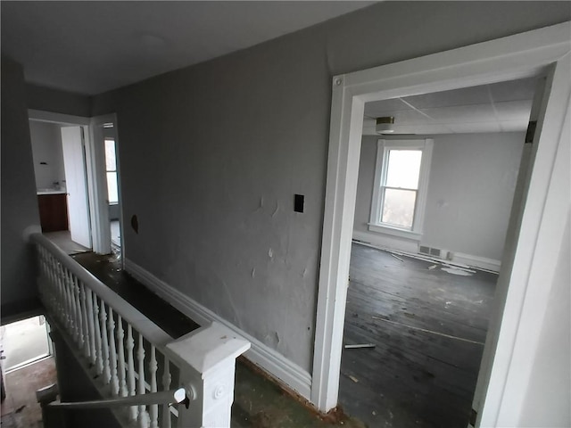 hallway with a paneled ceiling