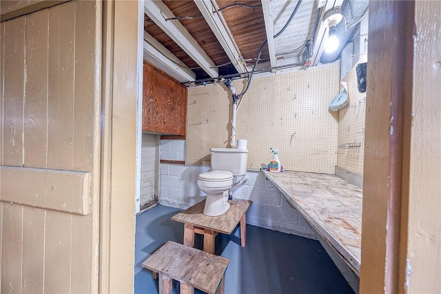 bathroom featuring concrete flooring and toilet