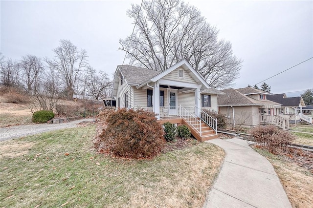 bungalow with a front yard and a porch