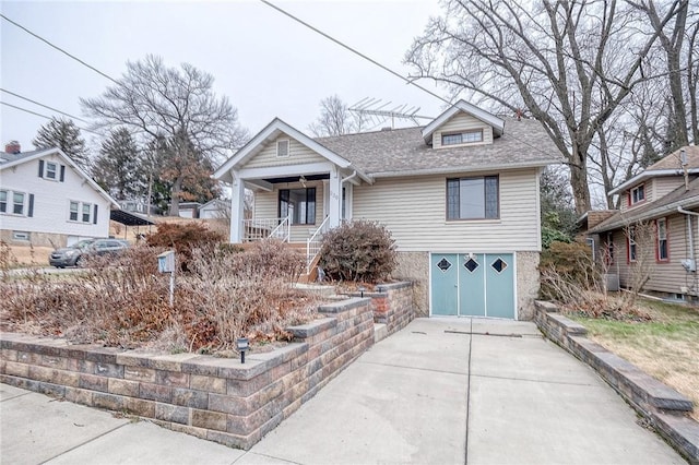 view of front of home with a garage and a porch