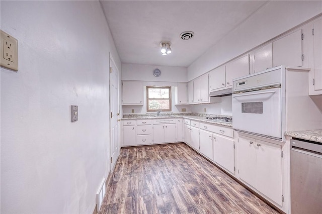 kitchen featuring white cabinetry, appliances with stainless steel finishes, sink, and hardwood / wood-style floors