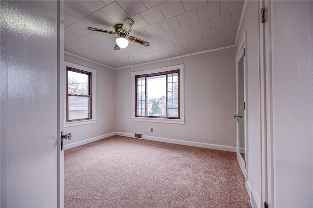 carpeted spare room with ornamental molding and ceiling fan