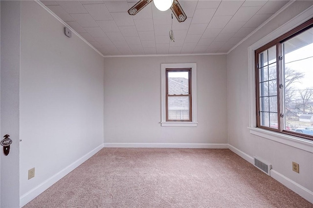 carpeted spare room with ornamental molding and ceiling fan