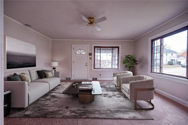 carpeted living room featuring ceiling fan and ornamental molding