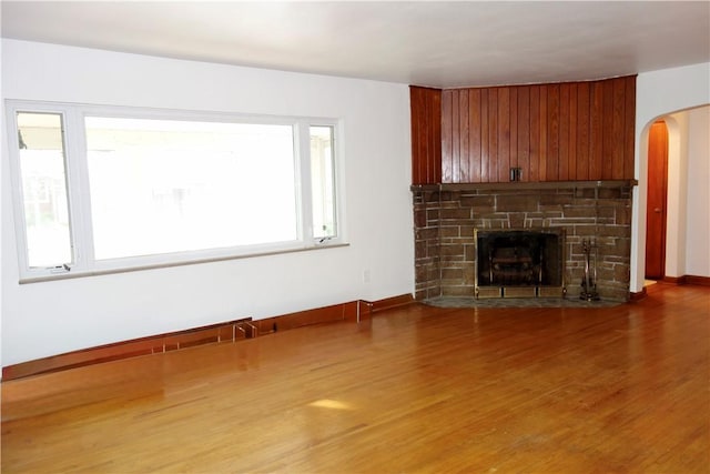 unfurnished living room with hardwood / wood-style flooring and a fireplace