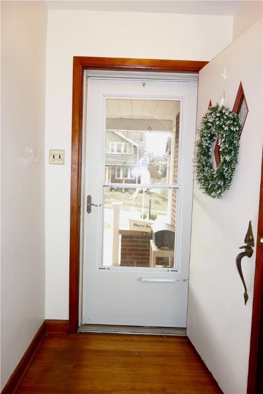 doorway to outside with wood-type flooring