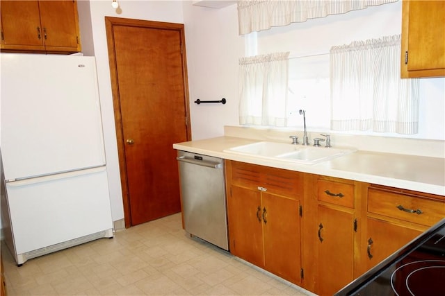 kitchen with dishwasher, white fridge, sink, and stove