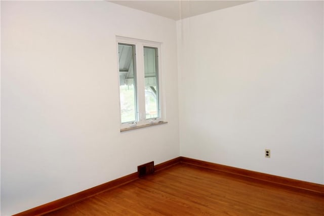 spare room featuring hardwood / wood-style flooring