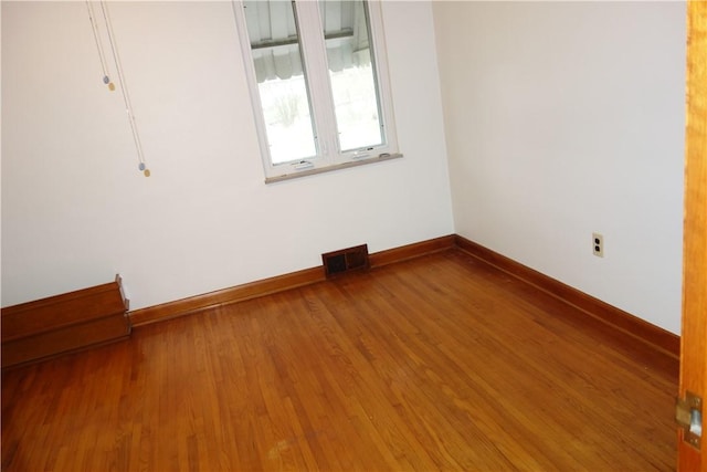 spare room with hardwood / wood-style floors