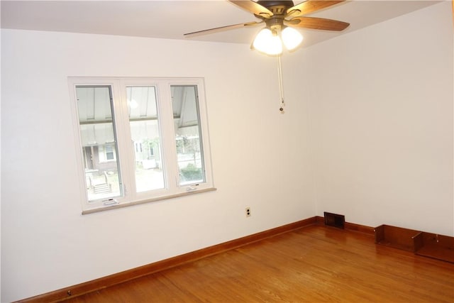 empty room with hardwood / wood-style flooring and ceiling fan