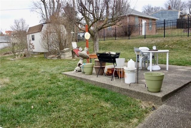 view of yard featuring a shed and a patio area