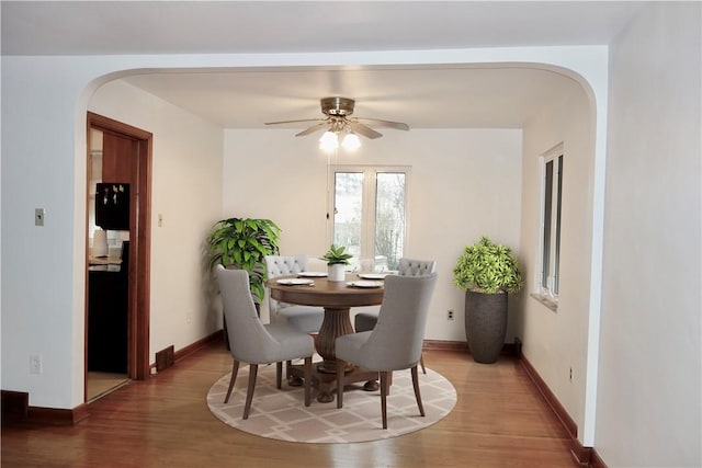 dining area featuring hardwood / wood-style flooring and ceiling fan