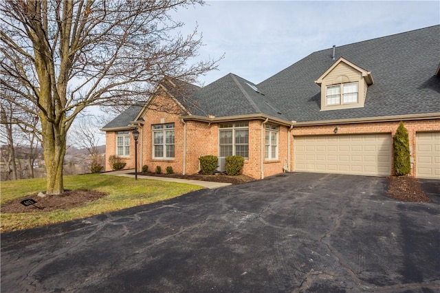 view of front of home featuring a garage and a front lawn