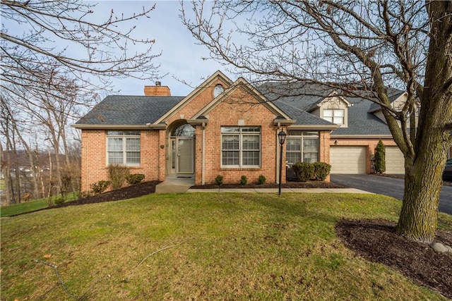 view of front of house featuring a garage and a front lawn