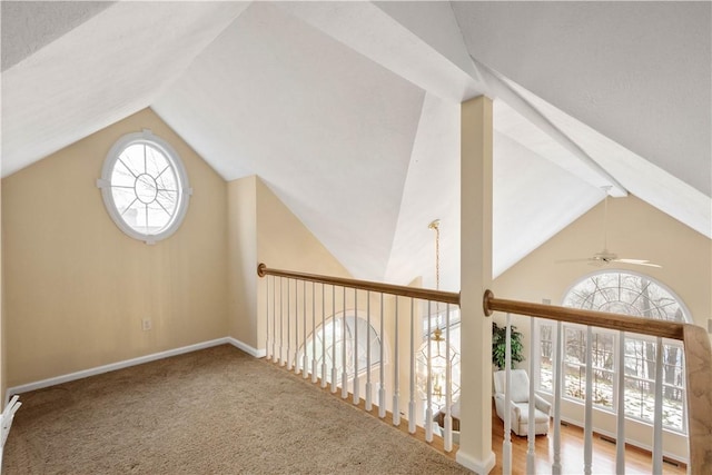 bonus room with carpet flooring and vaulted ceiling with beams