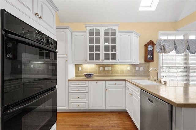 kitchen featuring white cabinetry, sink, and stainless steel dishwasher