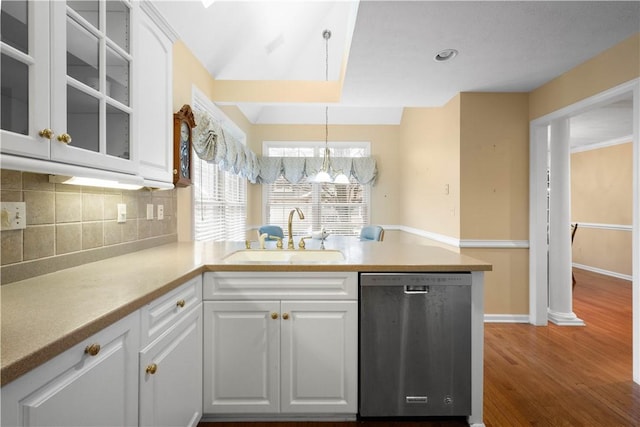 kitchen with white cabinetry, sink, stainless steel dishwasher, and decorative light fixtures