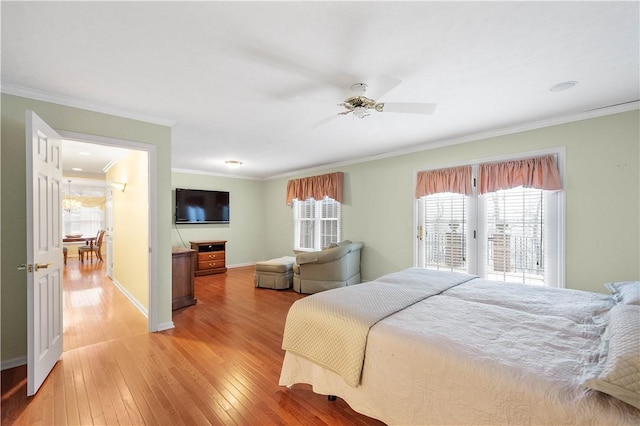 bedroom with ornamental molding, access to outside, and light hardwood / wood-style floors